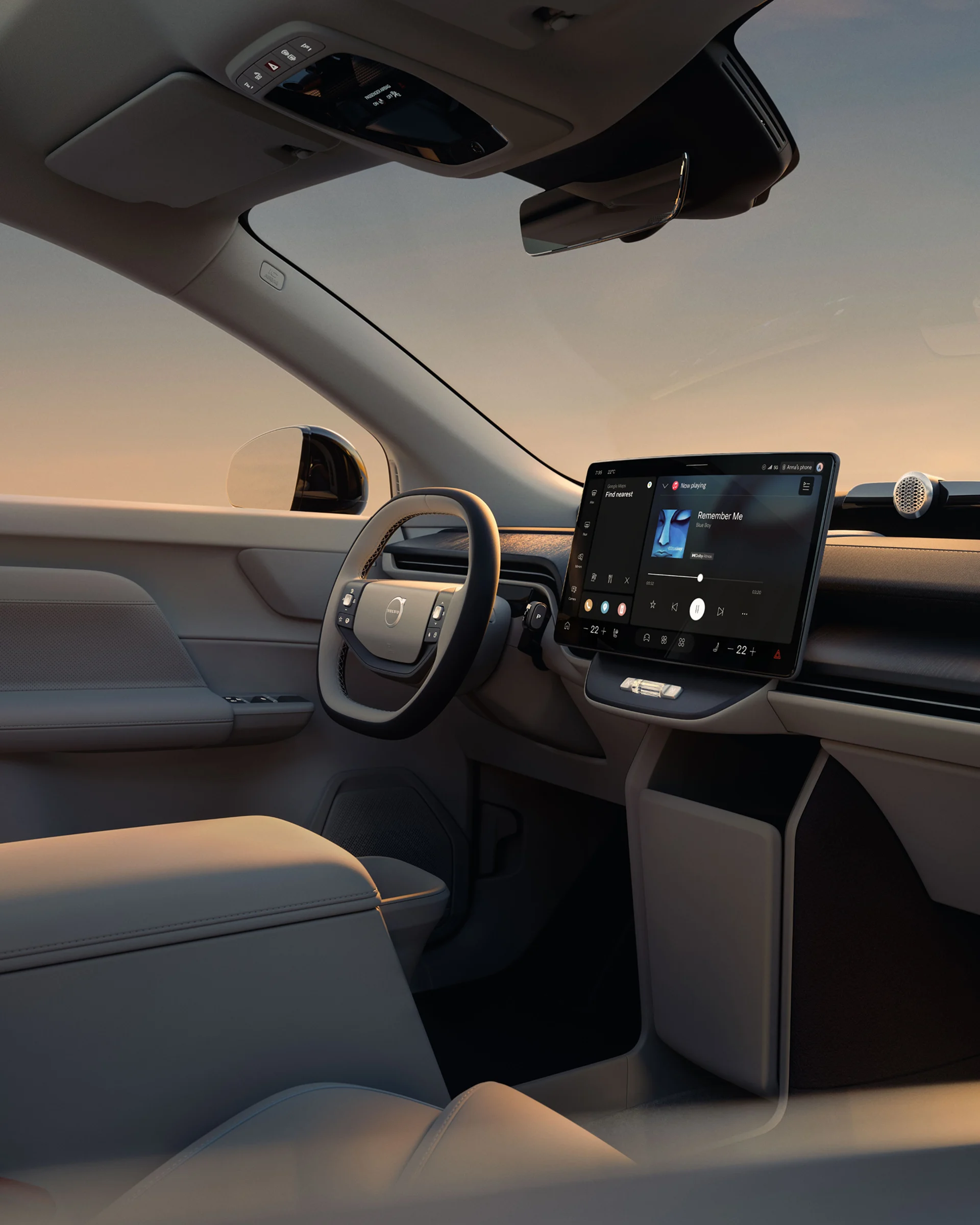 Салон Volvo EX60 с рулевым колесом, центральным дисплеем и передними сиденьями.