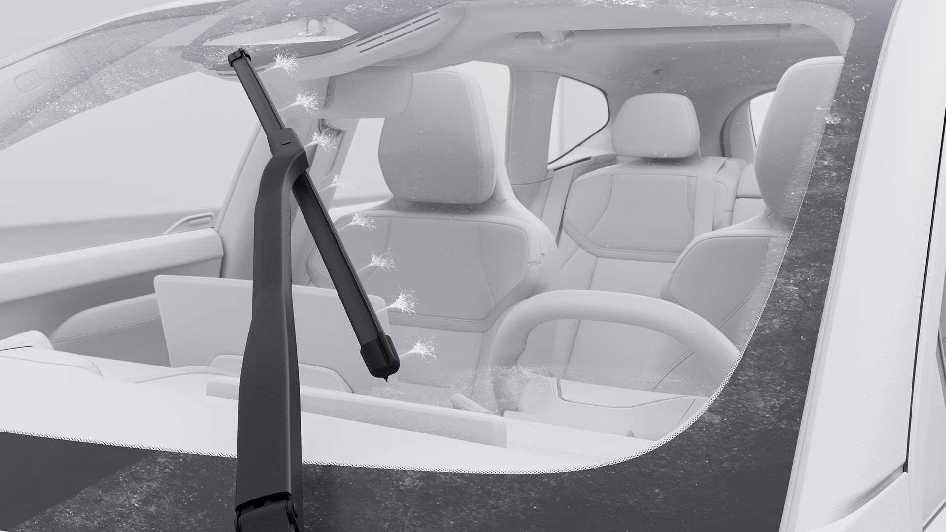 Стеклоочиститель Volvo, распыляющий чистящую жидкость на лобовое стекло, крупным планом, через стекло виден салон автомобиля.