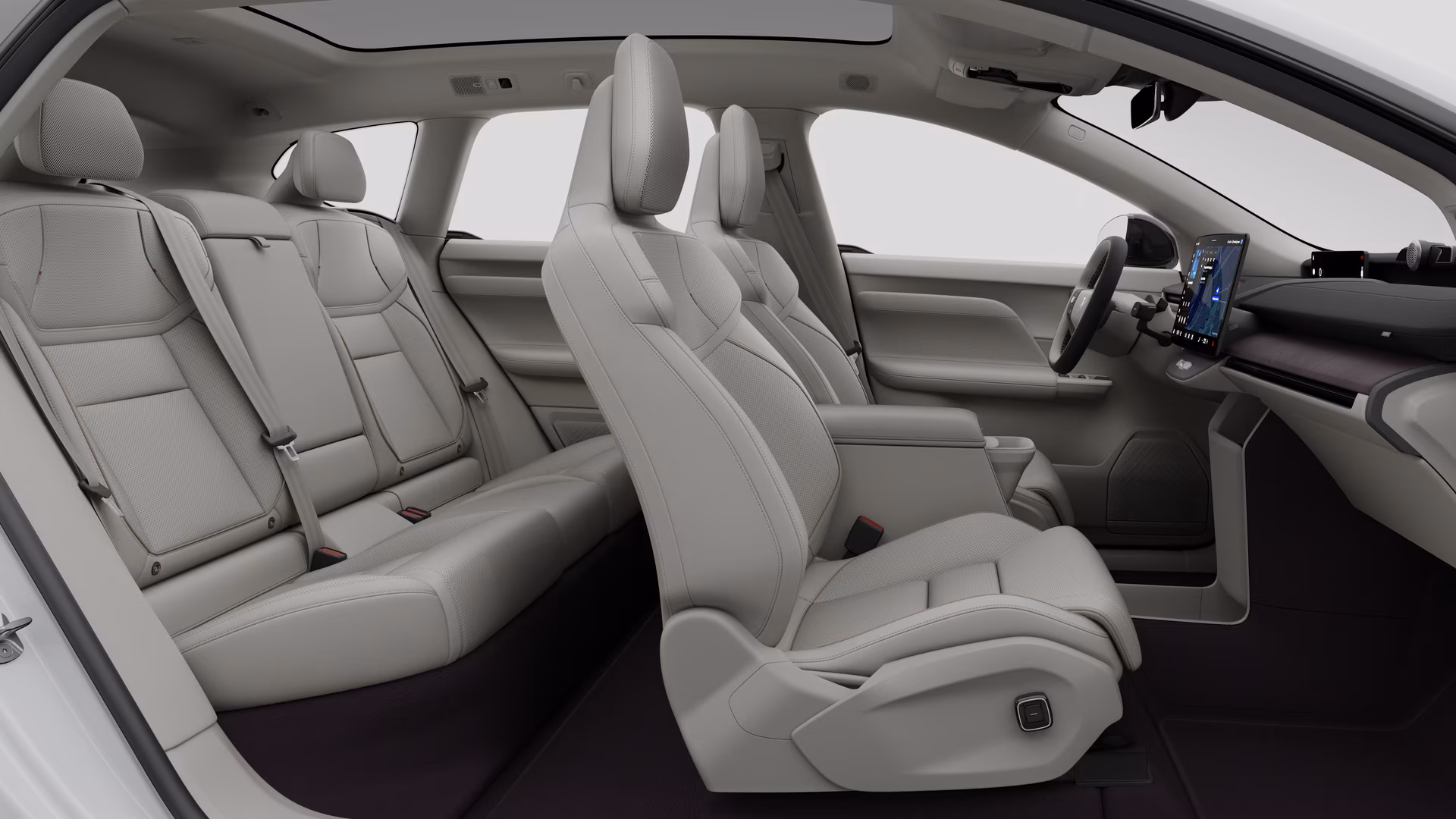 Салон автомобиля Volvo: передние сиденья, задние пассажирские сиденья, руль, приборная панель и центральная консоль на фоне студии.
