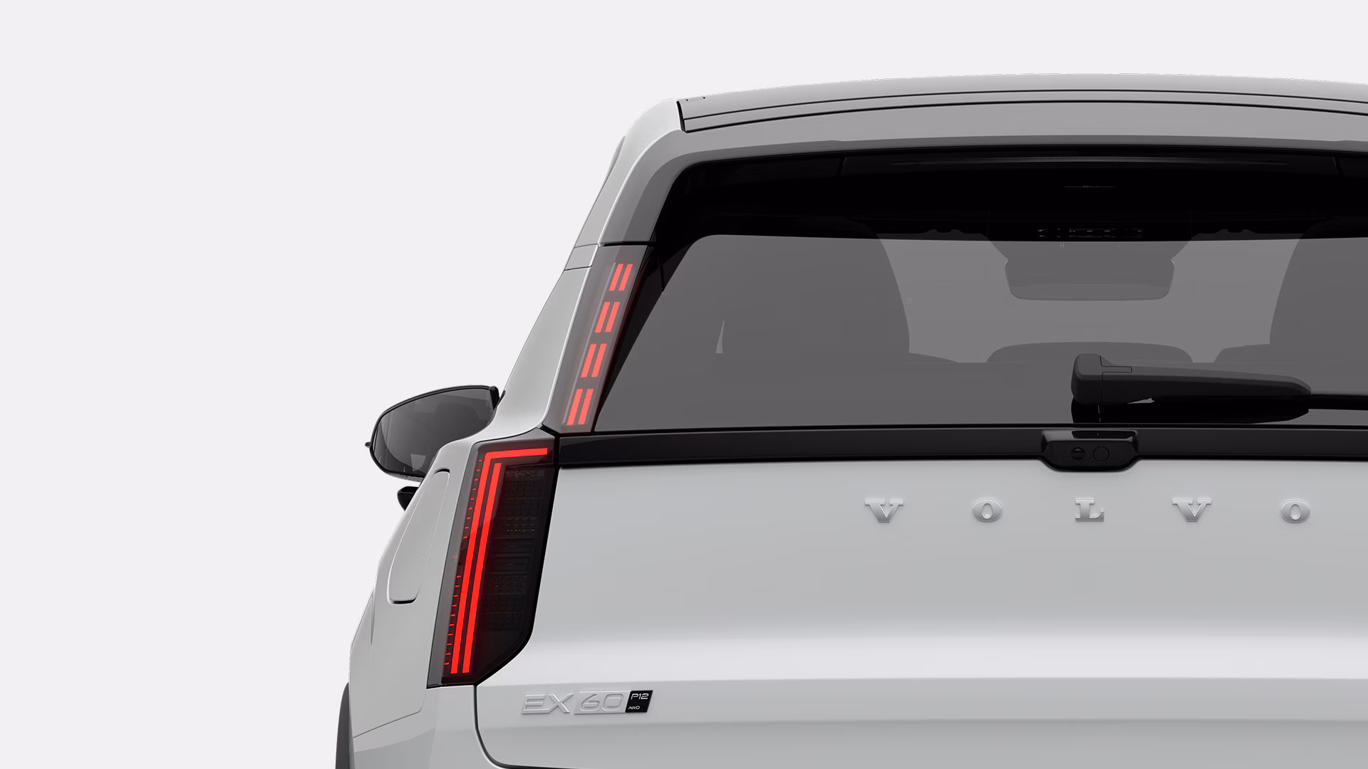 Вид сзади на Volvo EX60, демонстрирующий дизайн задних фонарей, заднее стекло и логотип Volvo на двери багажника.