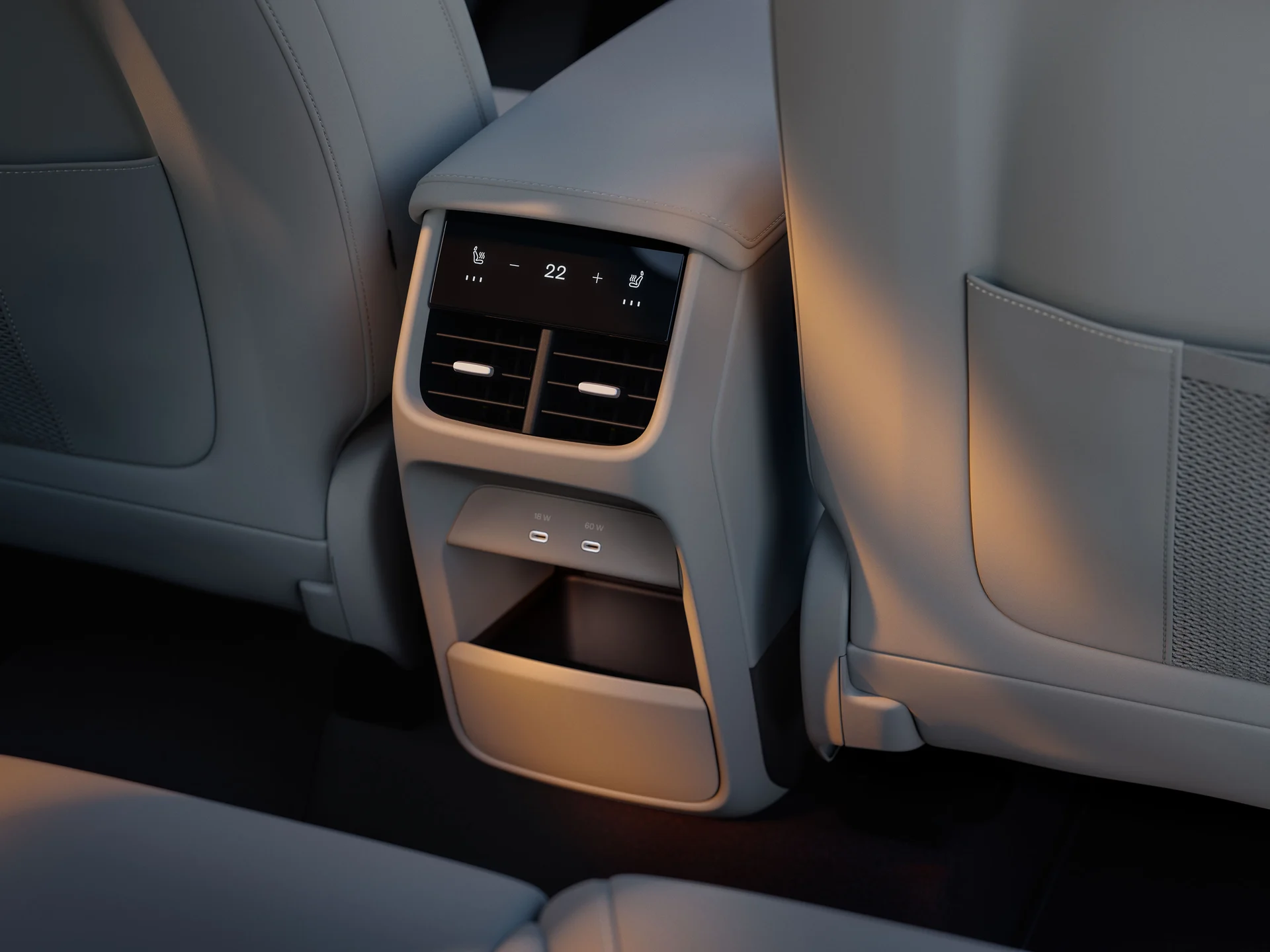 Задняя часть центральной консоли Volvo EX60 с климат-контролем, портами USB-C и нижним отсеком для хранения.