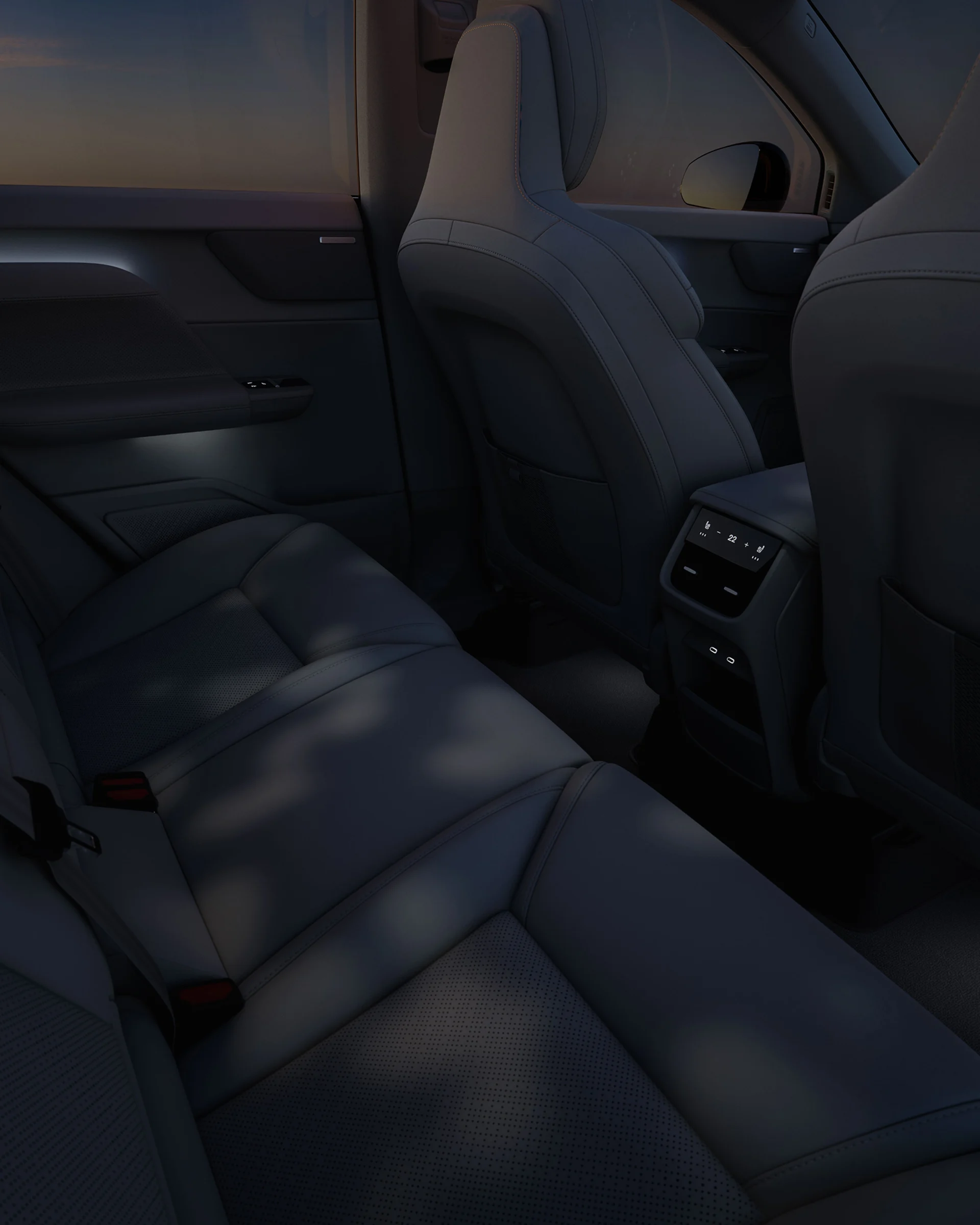 Задняя часть салона Volvo EX60 с проекцией Forest Light, создающей узорчатое рассеянное свечение на сиденьях.