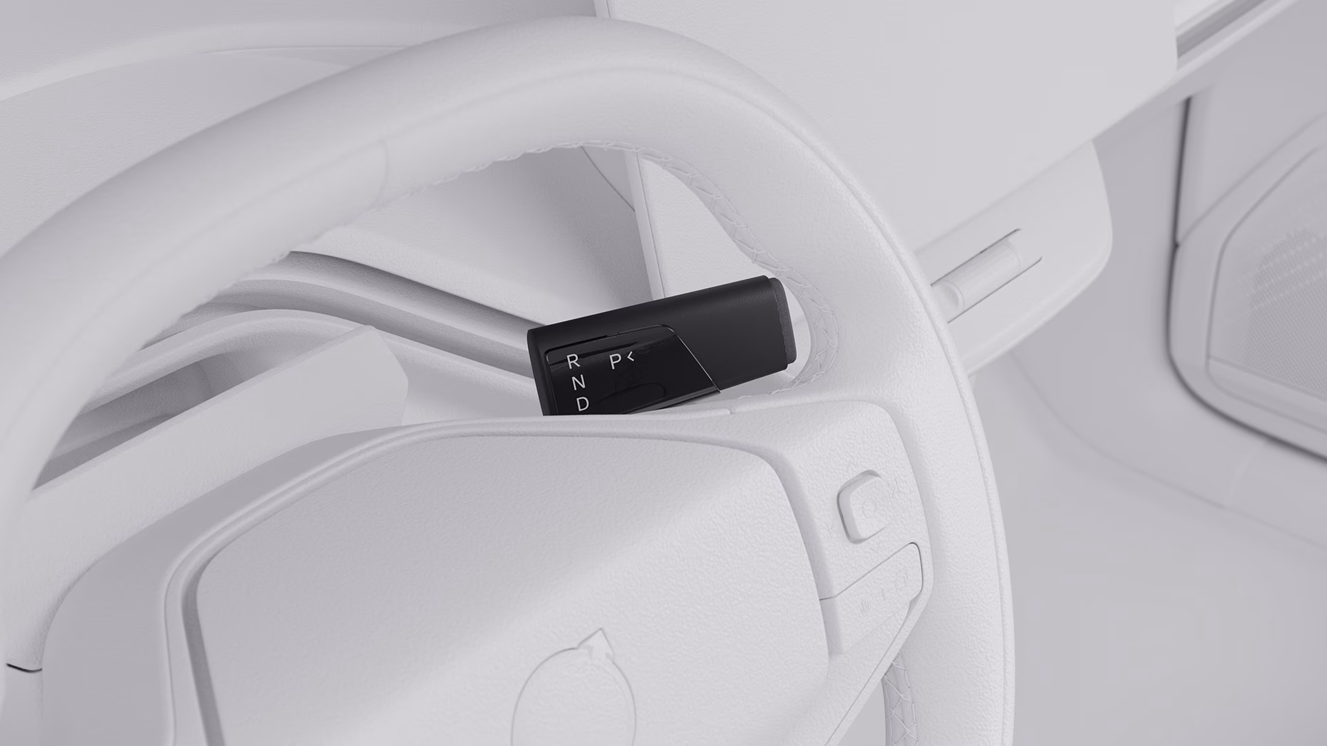 Крупный план рулевого колеса Volvo с селектором передач, показывающим положения парковки, заднего хода, нейтрали и движения.
