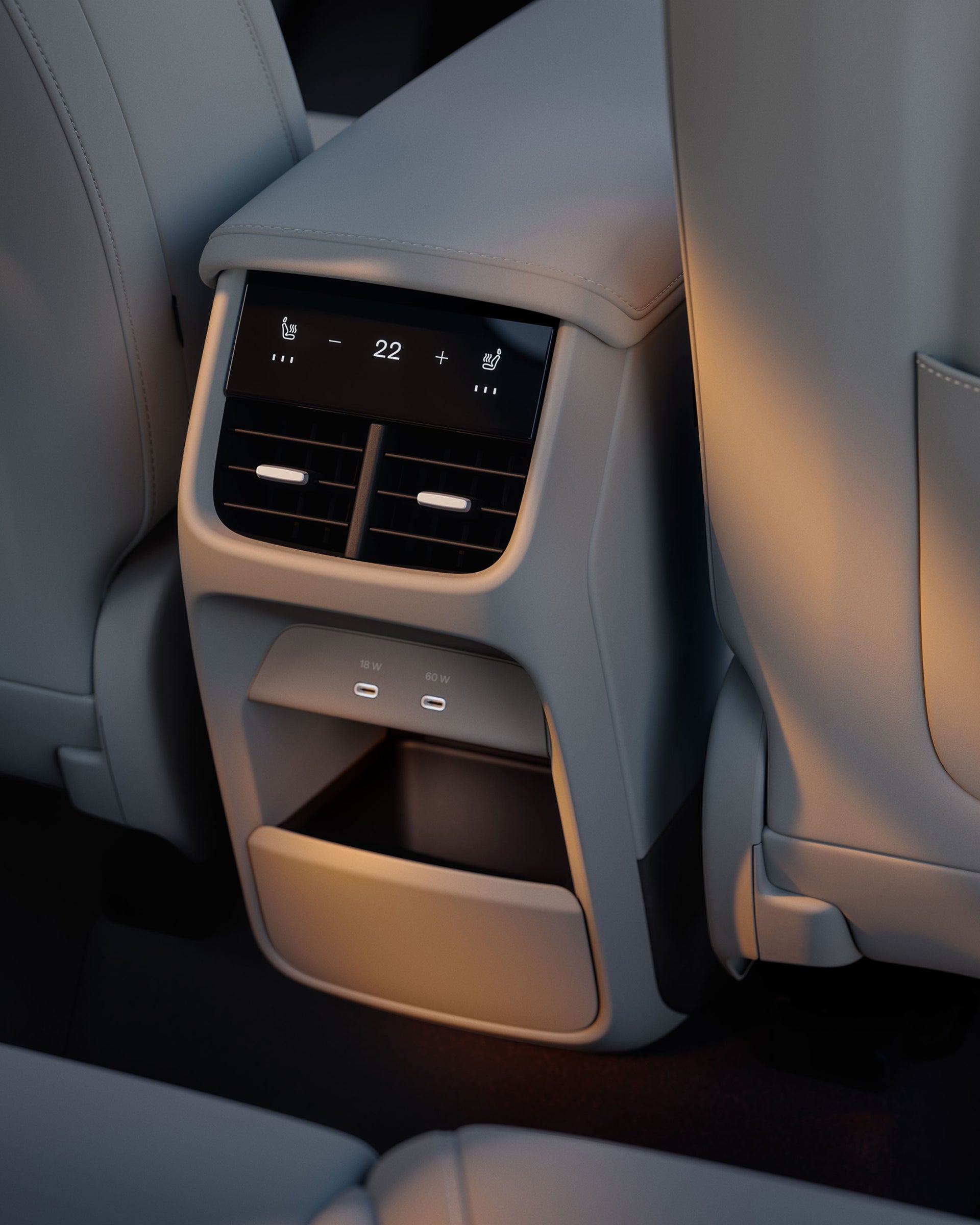 Задняя часть центральной консоли Volvo EX60 с климат-контролем, портами USB-C и нижним отсеком для хранения.