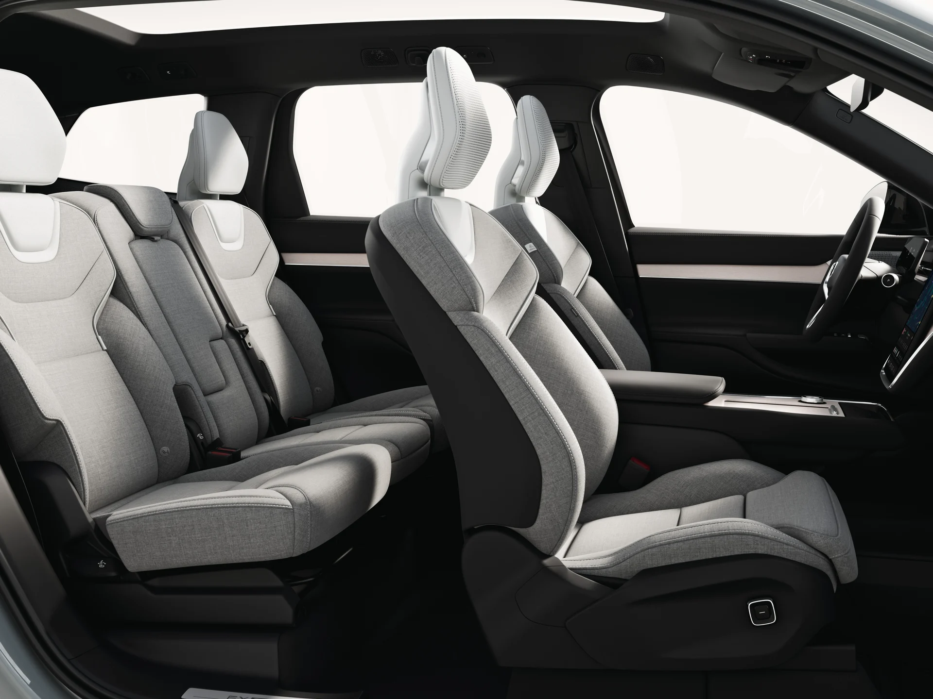 Открытый вид сбоку на просторный салон и центральную консоль Volvo EX90.