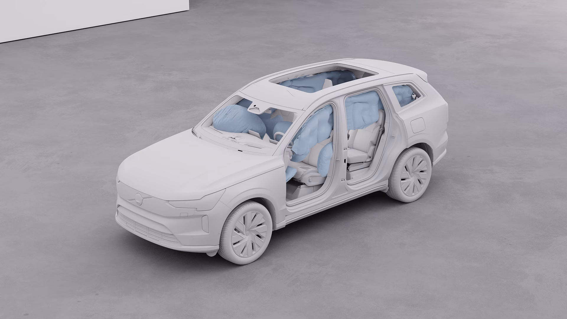 Модель автомобиля Volvo с открытыми дверями, демонстрирующая срабатывание нескольких подушек безопасности по всему салону для демонстрации безопасности.