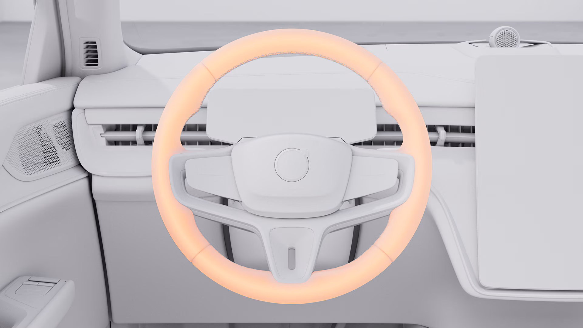 Крупный план рулевого колеса Volvo с подсвеченным оранжевым световым кольцом, подчеркивающим расширенные функции помощи водителю.