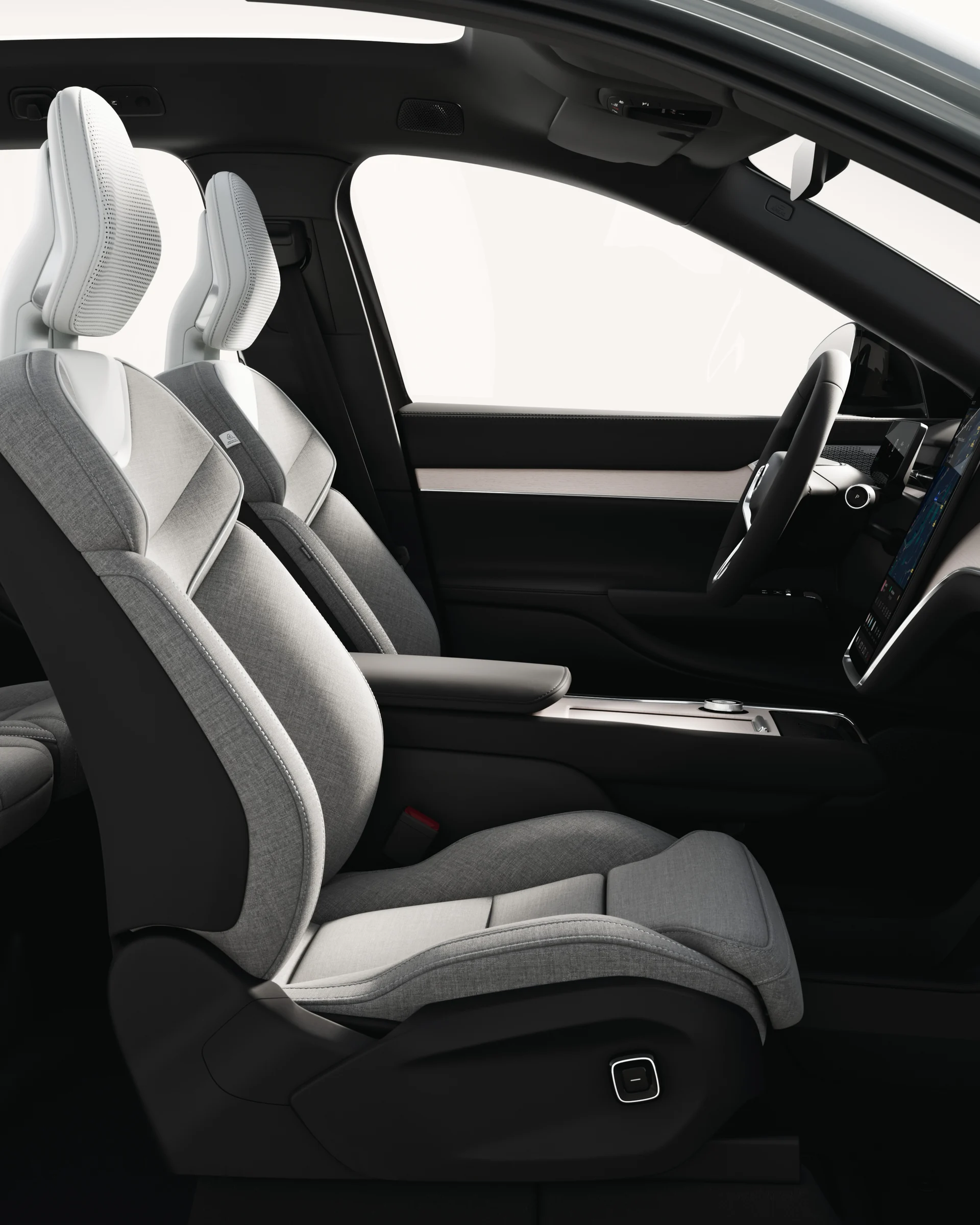 Открытый вид сбоку на просторный салон и центральную консоль Volvo EX90.