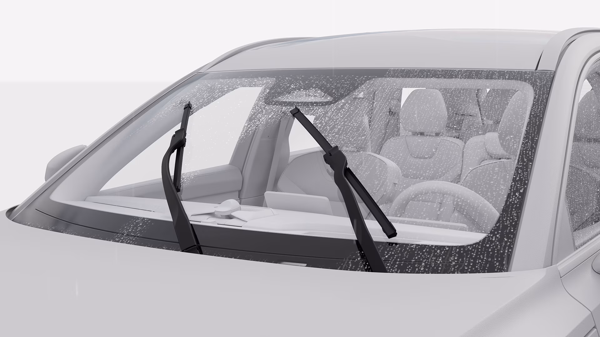 Крупный план лобового стекла автомобиля Volvo с каплями дождя, на котором видны стеклоочистители в движении.
