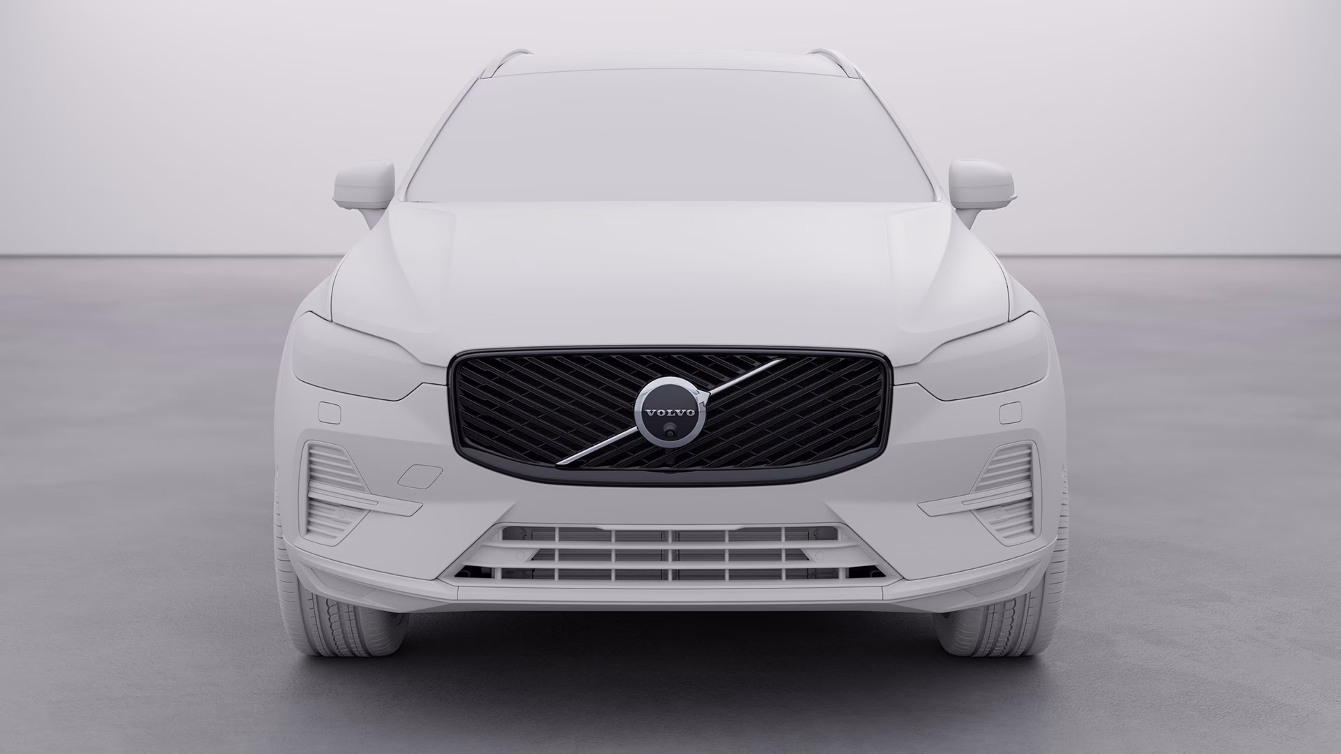 Вид спереди на кроссовер Volvo в нейтральной обстановке, фирменная решетка радиатора и эмблема Volvo.
