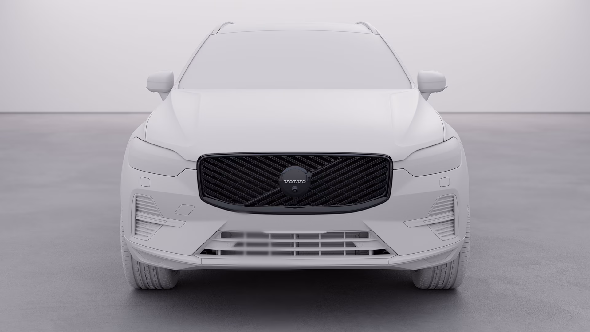 Вид спереди на внедорожник Volvo XC60 с черной решеткой радиатора в нейтральной обстановке.