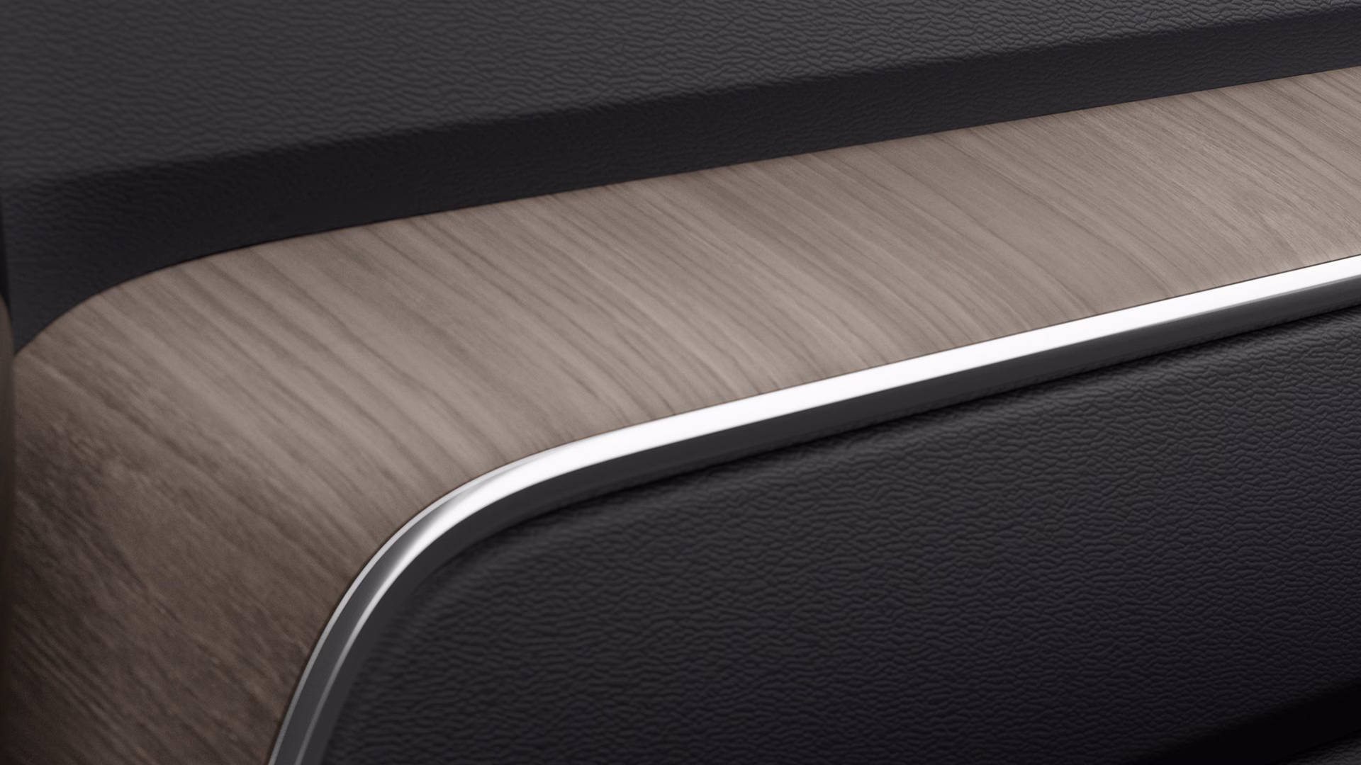 Крупный план отделки салона автомобиля Volvo с использованием натурального дерева и черных текстурированных материалов с металлическим акцентом.
