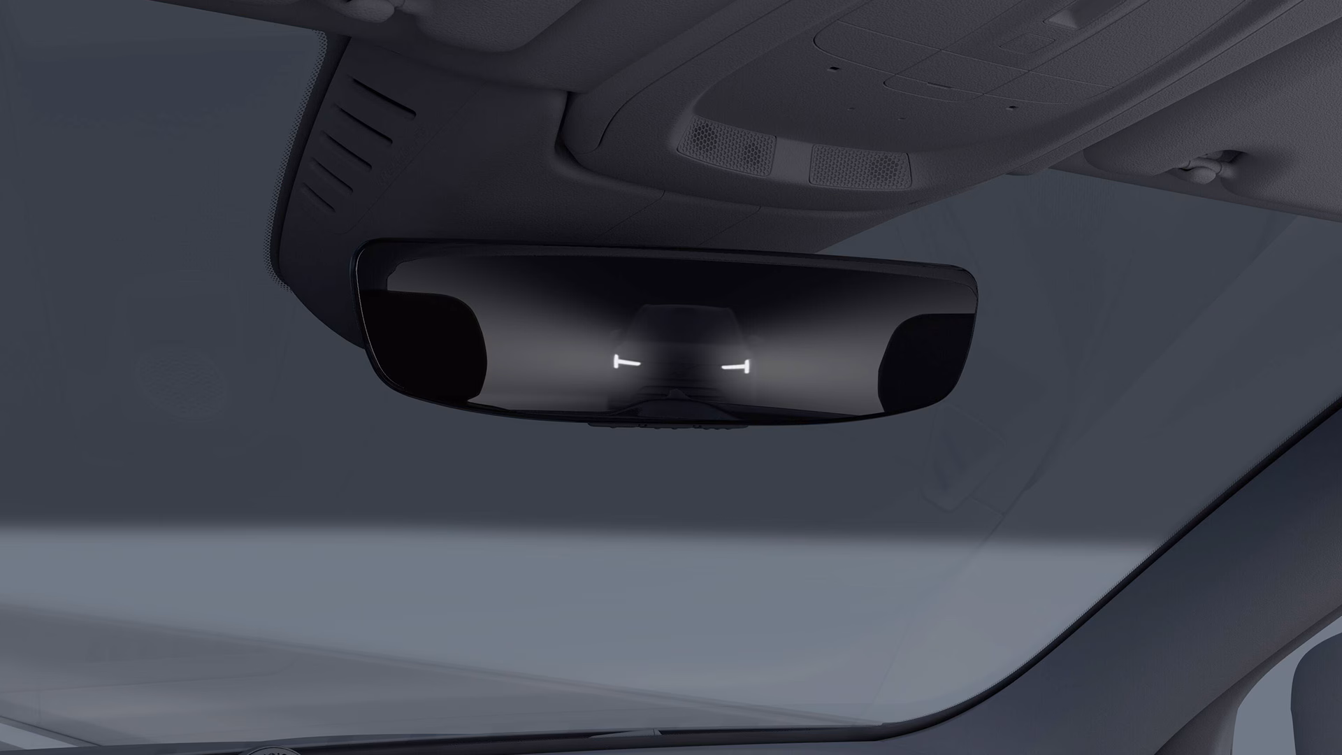 Цифровое зеркало заднего вида внутри автомобиля Volvo, отображающее фары движущегося сзади автомобиля.