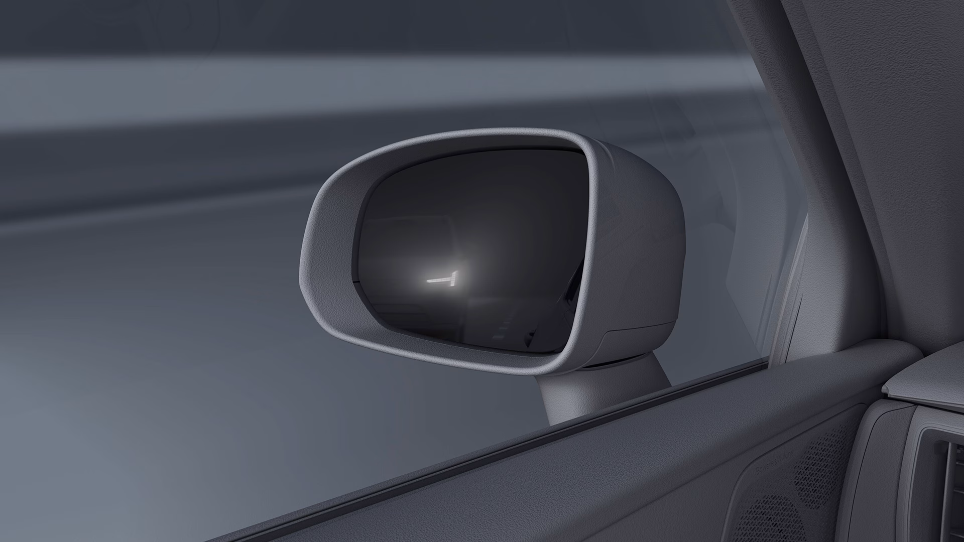 Крупный план бокового зеркала Volvo, на котором загорается сигнальный индикатор слепых зон.