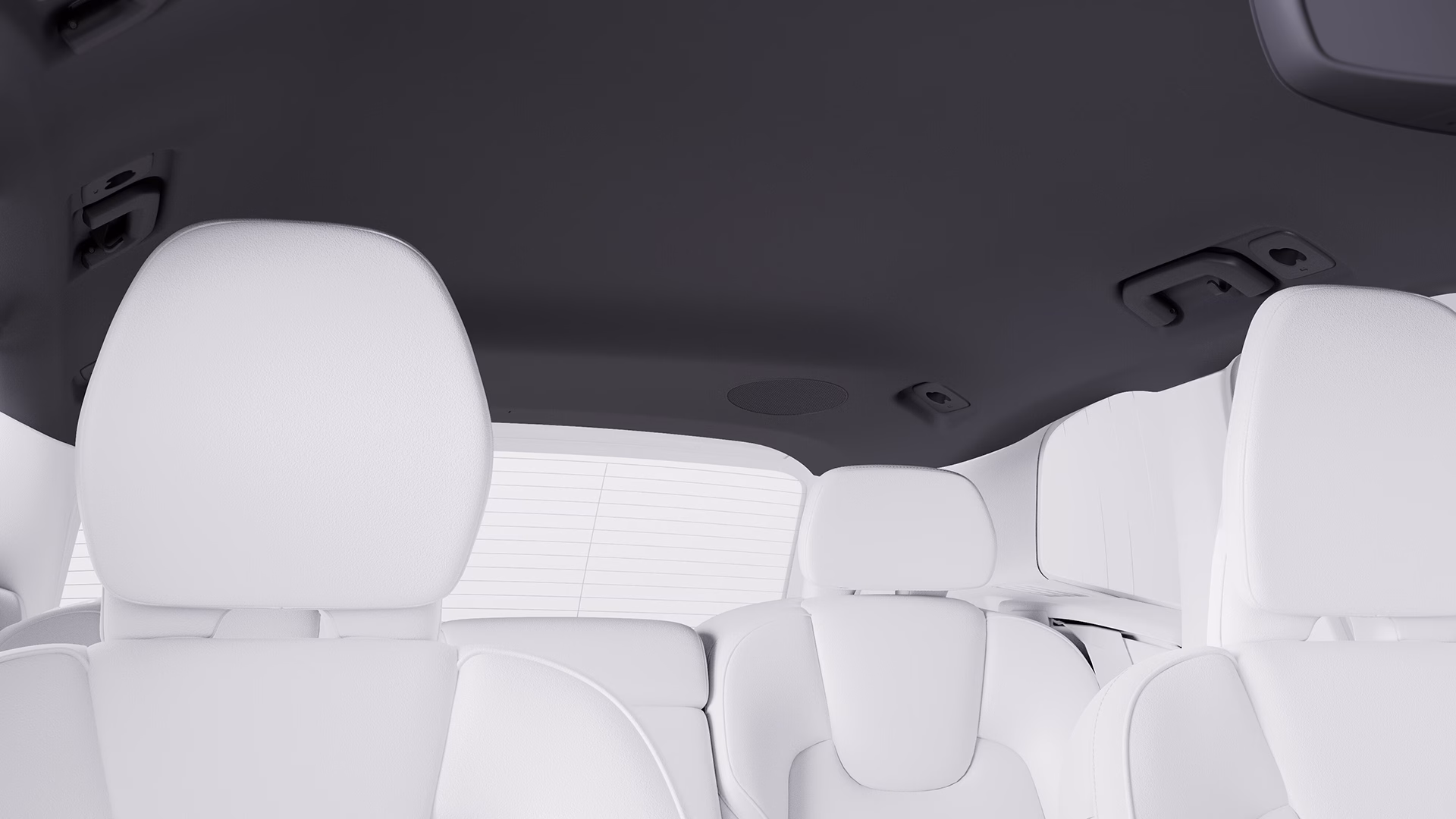Вид салона автомобиля Volvo с белыми кожаными сиденьями и черной обивкой крыши.