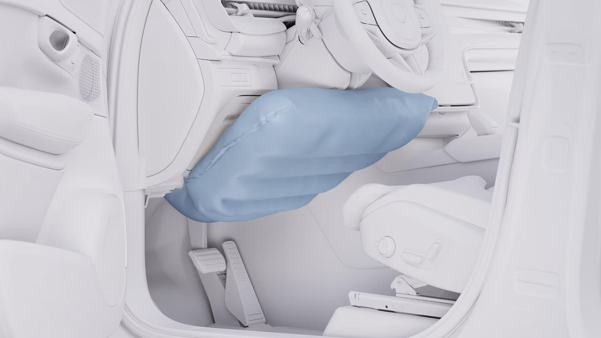 Крупный план салона автомобиля Volvo, на котором видна надутая коленная подушка безопасности под рулевой колонкой.