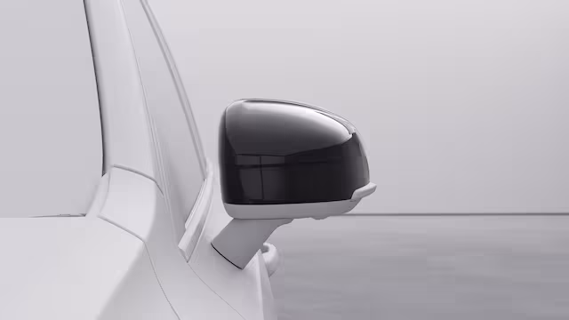 Боковое зеркало Volvo крупным планом с современным обтекаемым дизайном.
