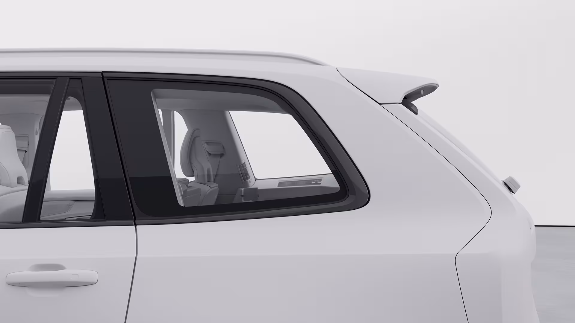 Крупный план заднего пассажирского окна и зоны сидений внедорожника Volvo, подчеркивающий детали дизайна интерьера и экстерьера.