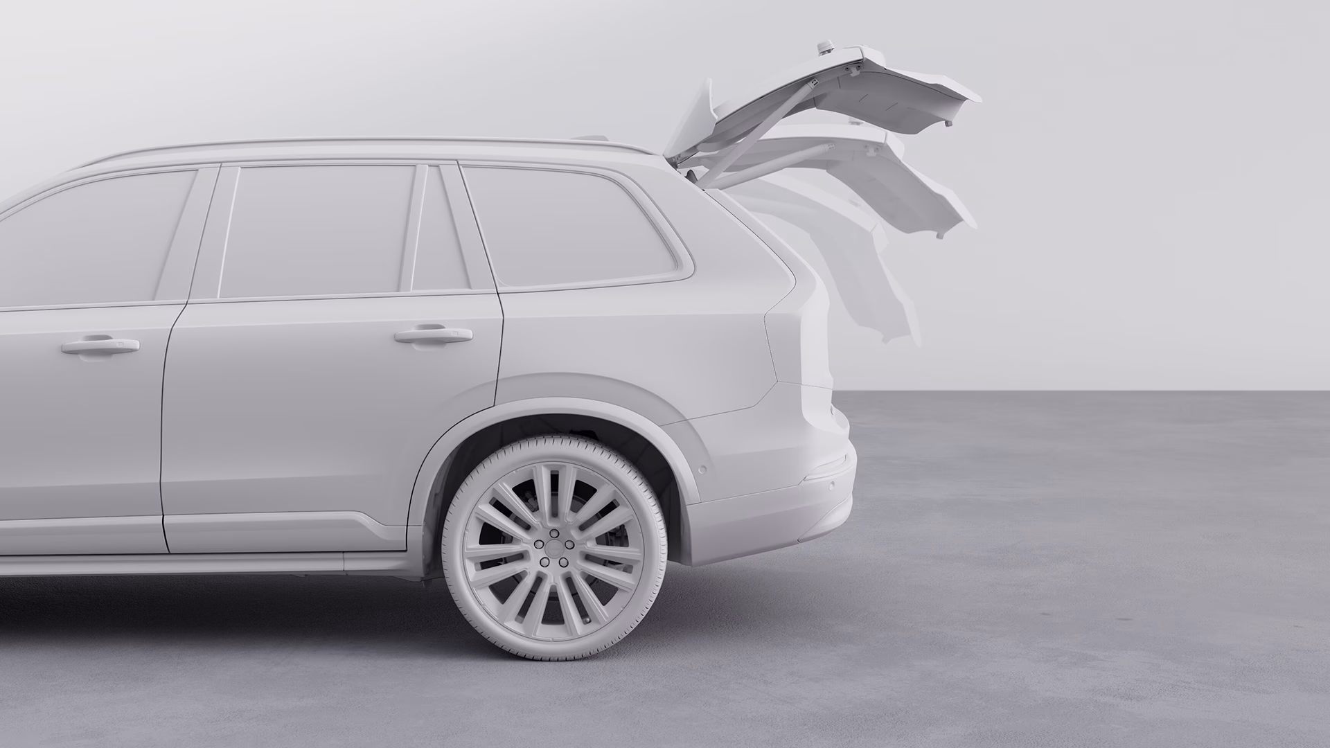 Вид сбоку на внедорожник Volvo с дверью багажника в нескольких открытых положениях.