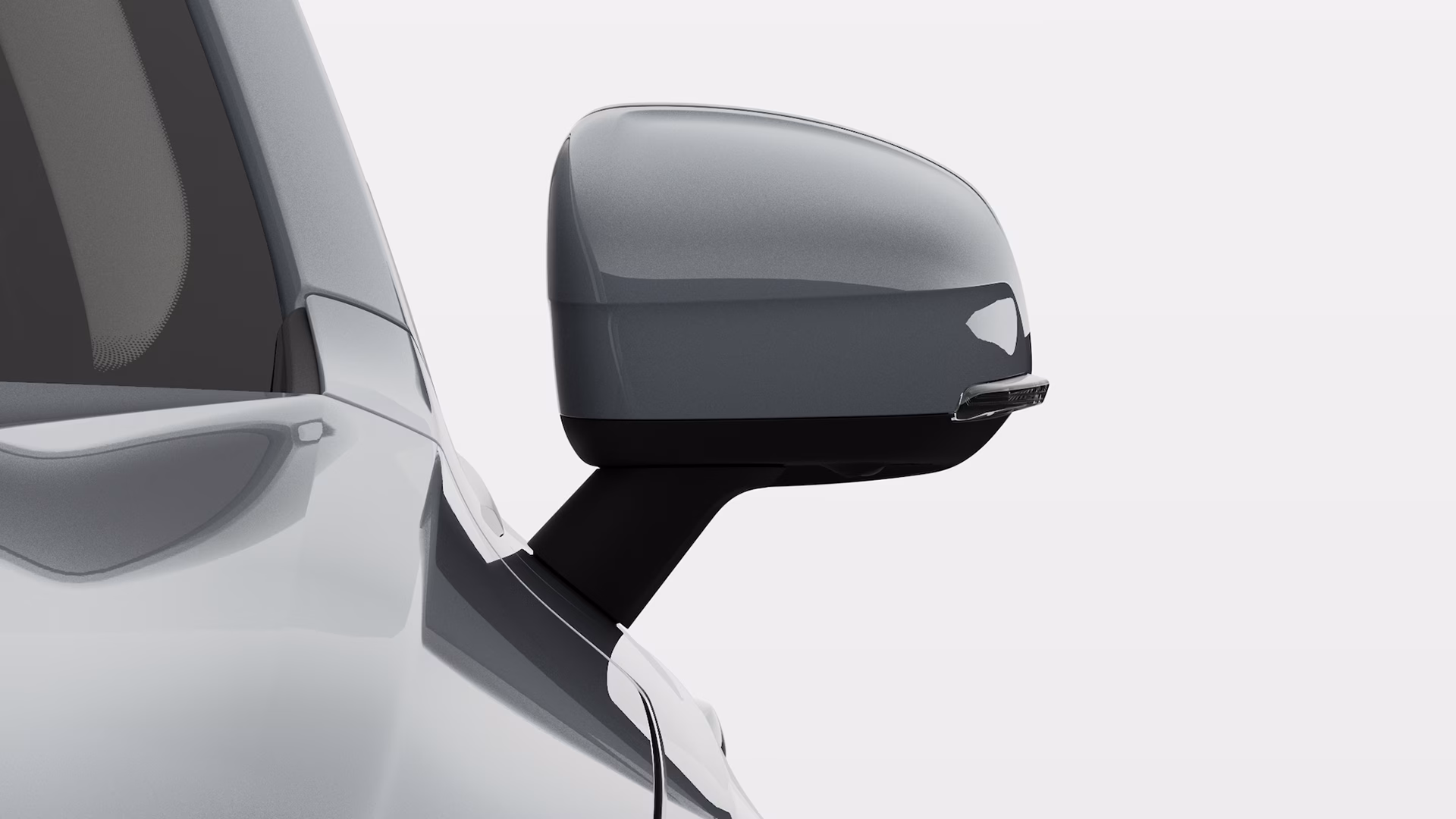 Боковое зеркало Volvo крупным планом, подчеркивающее его элегантный дизайн.